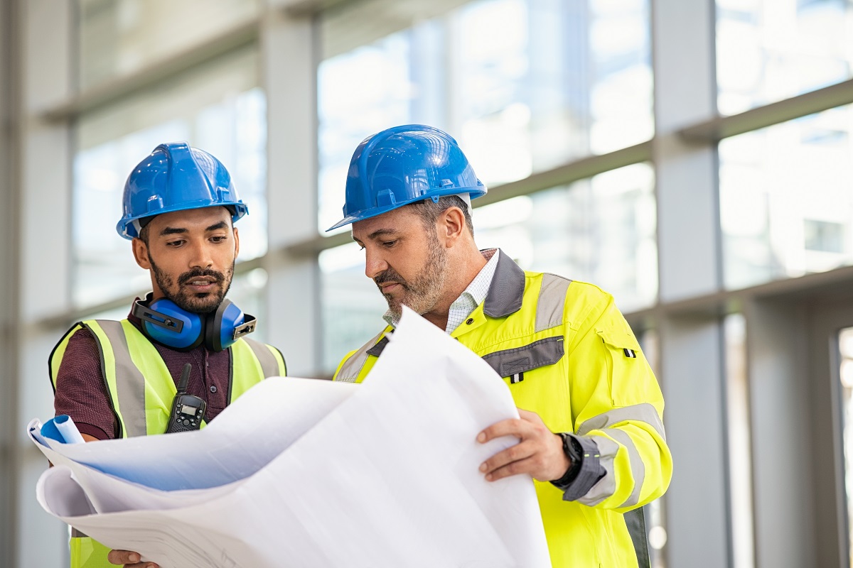 male contractors checking the blueprint