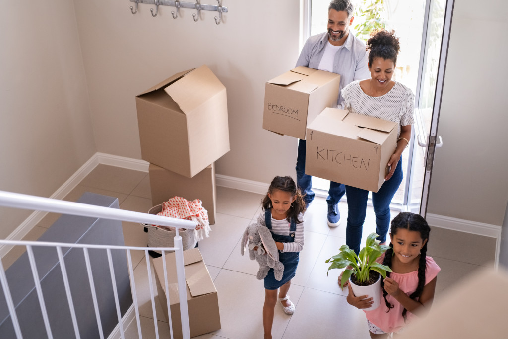 family carrying boxes